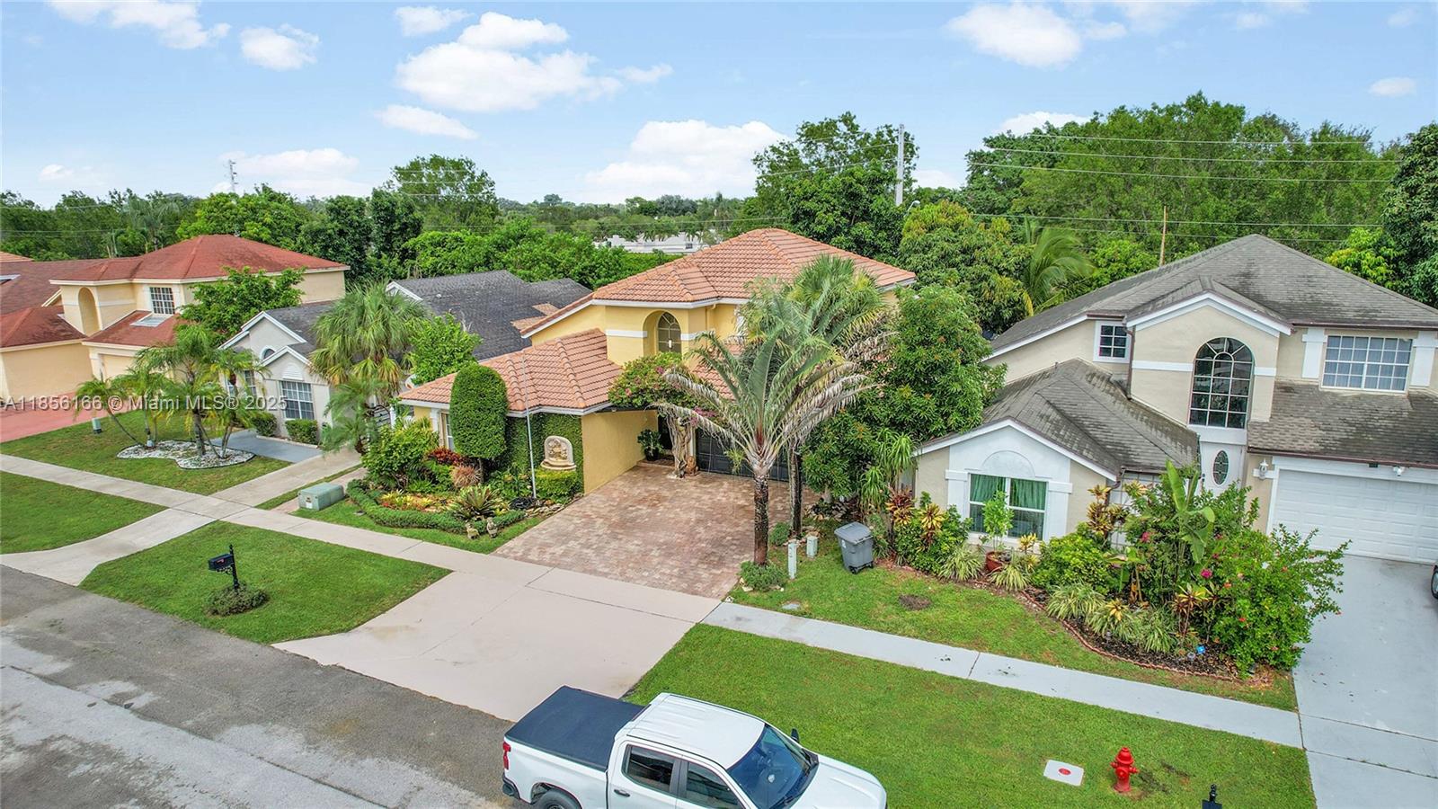 9398 Aegean Drive Boca Raton, FL 33496 - Photo 54 of 61 a front view of a house with a garden and yard