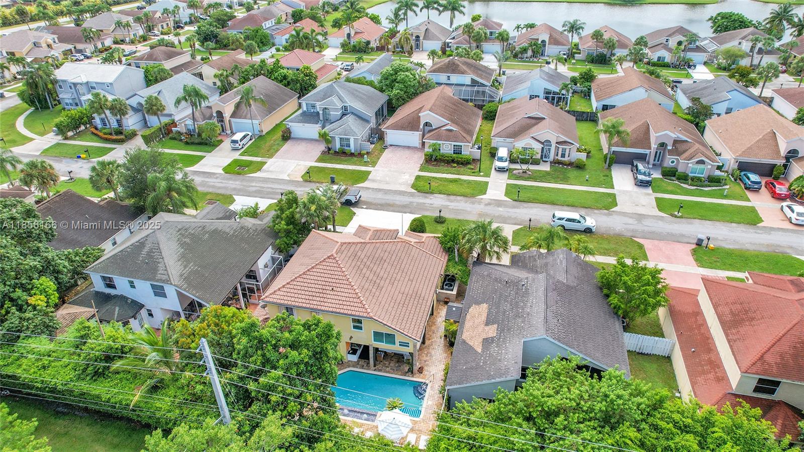 9398 Aegean Drive Boca Raton, FL 33496 - Photo 55 of 61 an aerial view of residential houses with outdoor space and parking