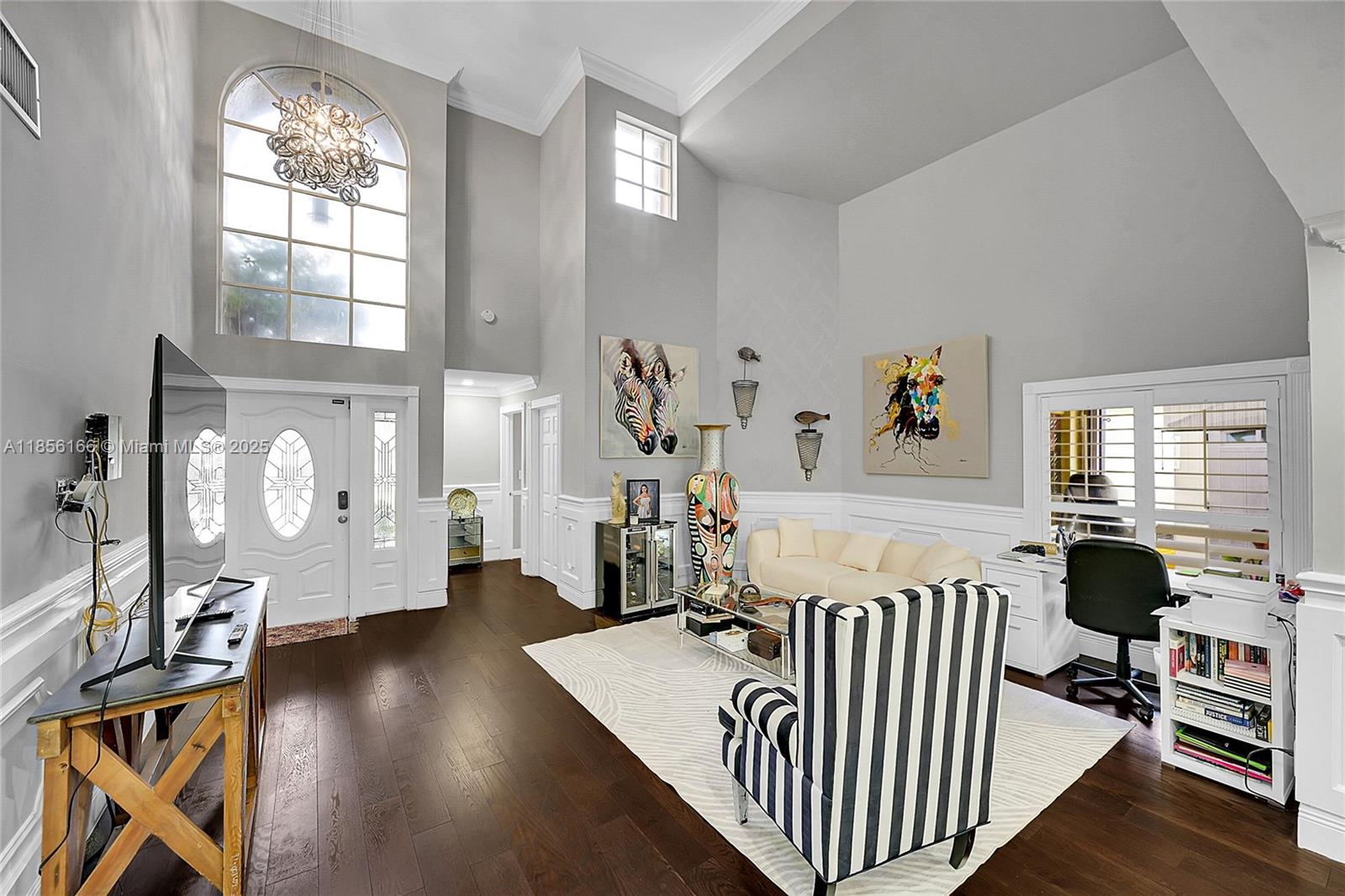 9398 Aegean Drive Boca Raton, FL 33496 - Photo 7 of 61 a view of a livingroom with furniture hardwood floor and a chandelier