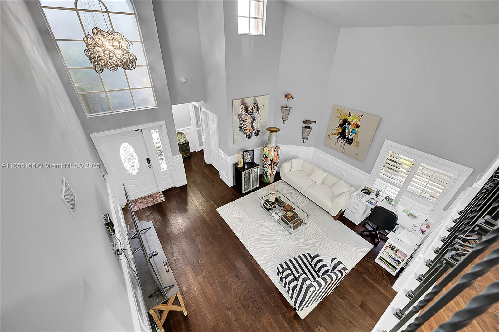 9398 Aegean Drive Boca Raton, FL 33496 - Photo 9 of 61 a living room with furniture and a chandelier