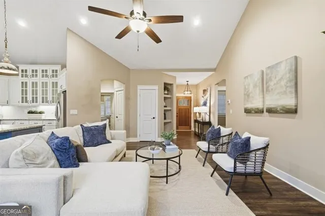 a kitchen with stainless steel appliances a dining table chairs and chandelier