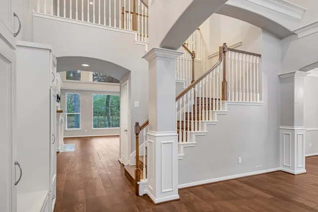 a view of an entryway with wooden floor and door