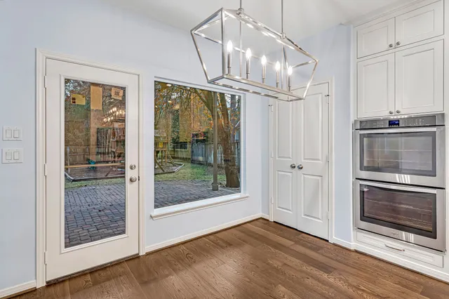 a view of an empty room wooden floor and a fireplace