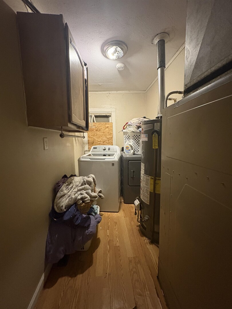 1615 West Chestnut Street Marion, IL 62959 - Photo 7 of 18 a room with water heater and a wooden floor