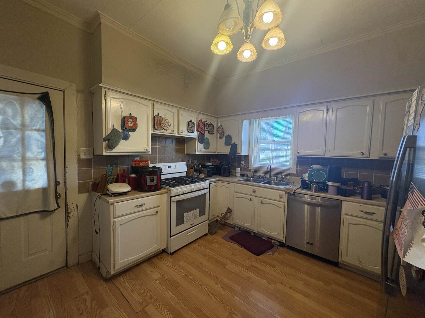 1615 West Chestnut Street Marion, IL 62959 - Photo 10 of 18 a kitchen with a stove top oven sink and cabinets