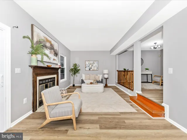 a living room with fireplace furniture and a fireplace