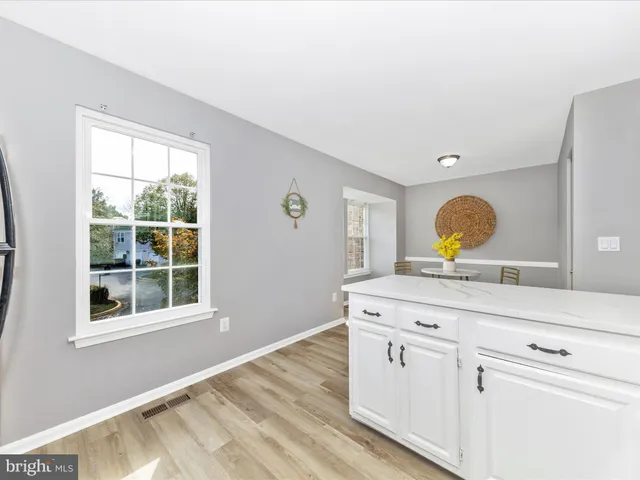 a view with a sink and mirror with wooden floor