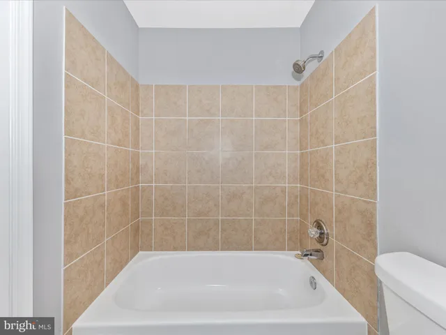 a bath tub sitting next to a white toilet