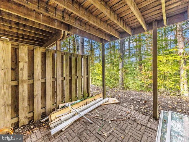 a porch with a table and chairs