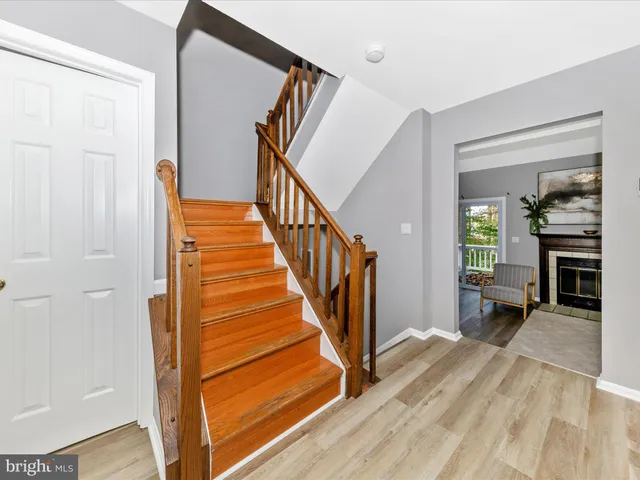 a view of a hallway view with wooden floor and staircase