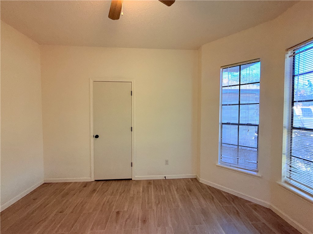 2229 Pebble Beach Drive Ingleside, TX 78362 - Photo 18 of 33 a view of an empty room with window and wooden floor