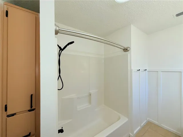 a bathroom with a shower and a glass door