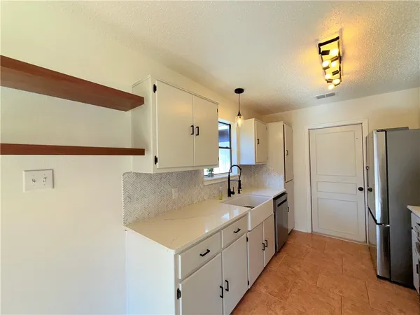 a bathroom with a double vanity sink and mirror