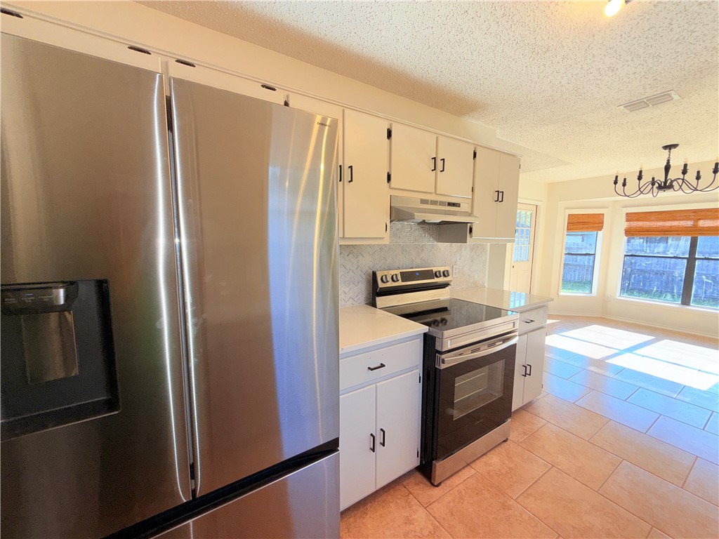 2229 Pebble Beach Drive Ingleside, TX 78362 - Photo 8 of 33 a kitchen with stainless steel appliances granite countertop a refrigerator and a stove
