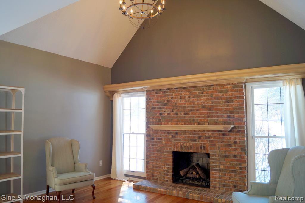 1334 Hathaway Rising Rochester, MI 48306 - Photo 9 of 36 Gas fireplace in living room with vaulted ceiling