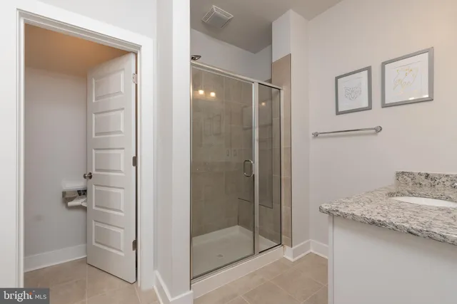 a bathroom with a granite countertop sink a shower and