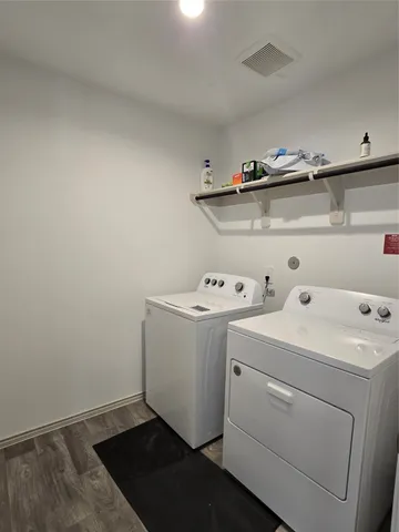 a view of storage and utility room with washer and dryer