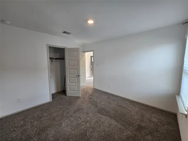 a view of an empty room and closet