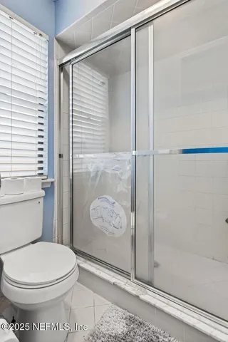a bathroom with a toilet and a shower