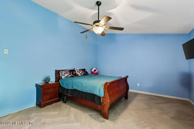 a bedroom with a bed and a chandelier