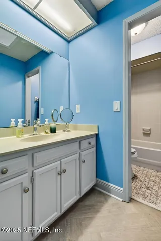 a bathroom with double sink and a mirror