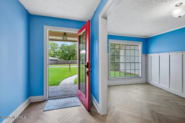 a view of an empty room with a fireplace and yard