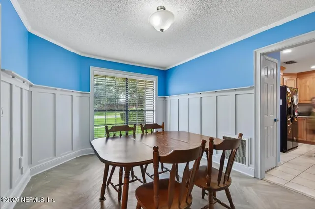a view of a dining room with furniture and window