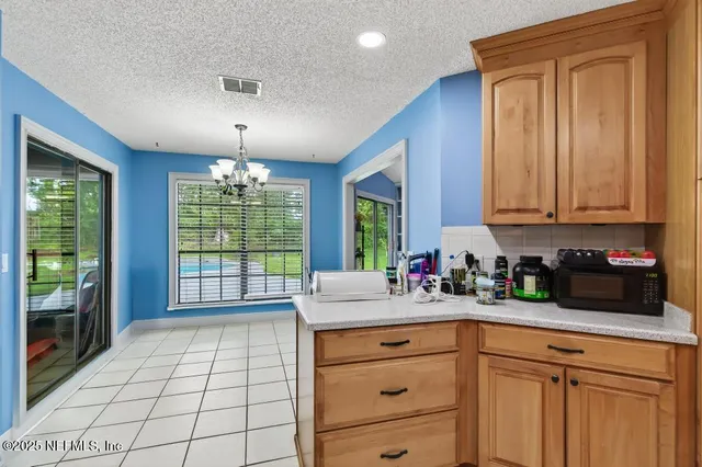 a kitchen with a sink cabinets and window