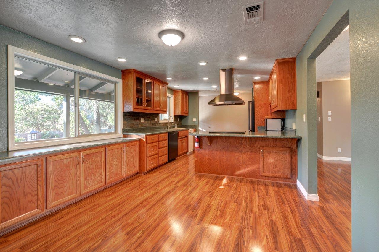 833 Upper Applegate Road Jacksonville, OR 97530 - Photo 11 of 58 a large kitchen with stainless steel appliances granite countertop a large counter top a stove and a wooden floors
