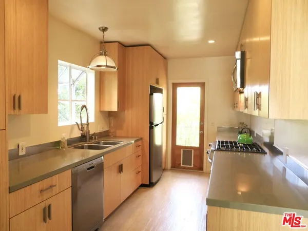 a kitchen with a sink stove and refrigerator