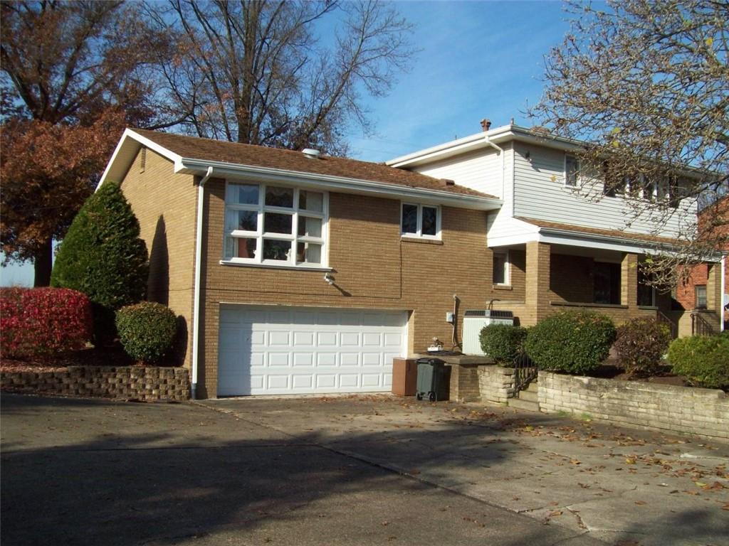 124 Herbst Road Coraopolis, PA 15108 - Photo 2 of 24 a front view of a house with a yard and garage