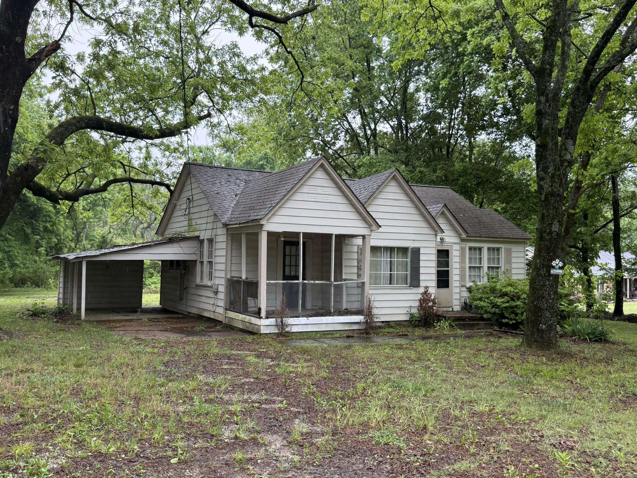 8488 Quito Road Millington, TN 38053 - Photo 2 of 30 a front view of a house with a garden and trees