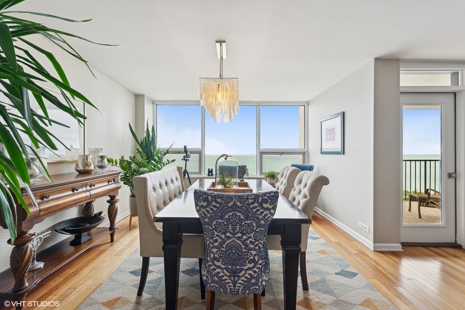 5733 North Sheridan Road, Unit 29D Chicago, IL 60660 - Photo 15 of 40 a view of a dining room with furniture window and wooden floor