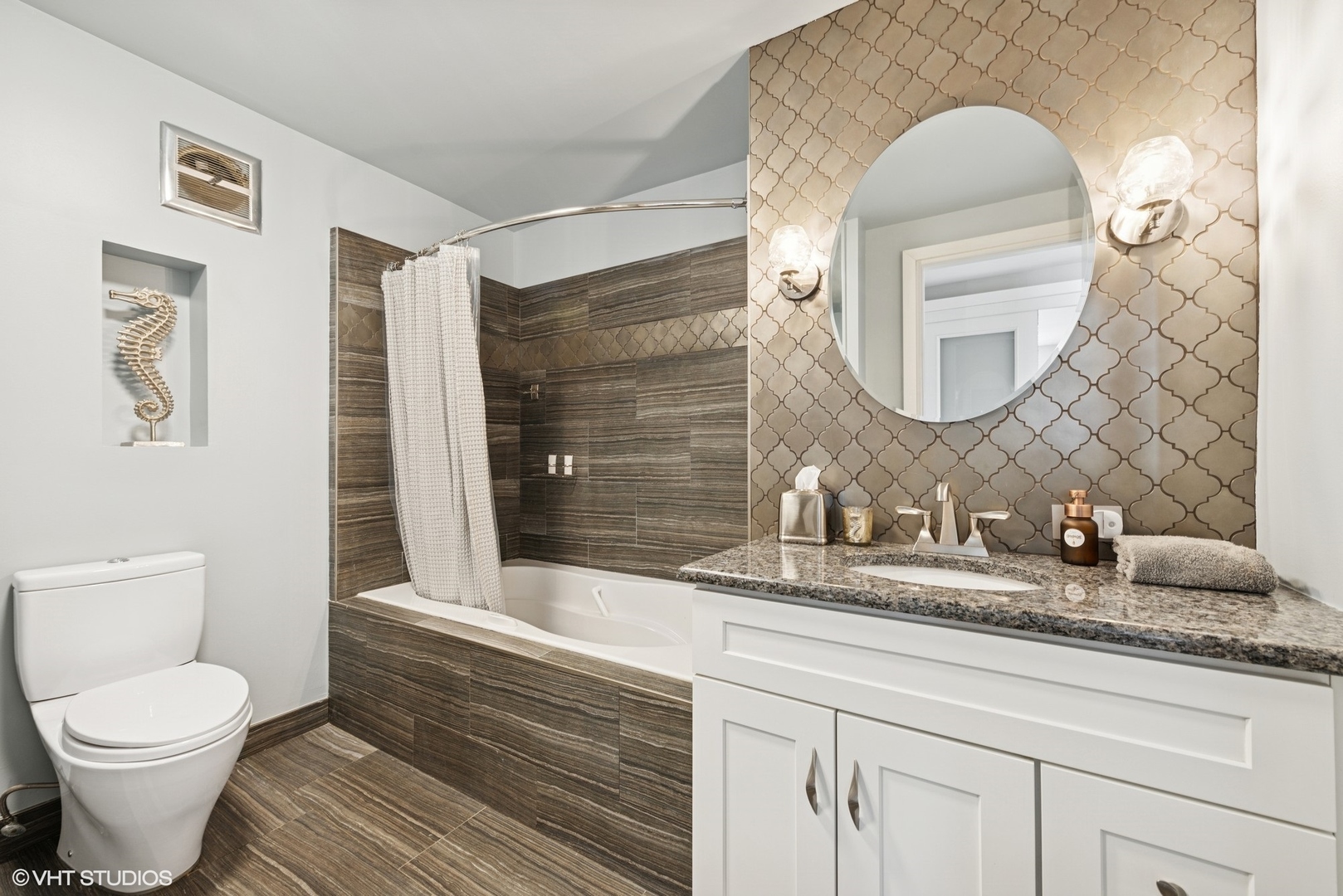 5733 North Sheridan Road, Unit 29D Chicago, IL 60660 - Photo 28 of 40 a bathroom with a granite countertop toilet sink and mirror