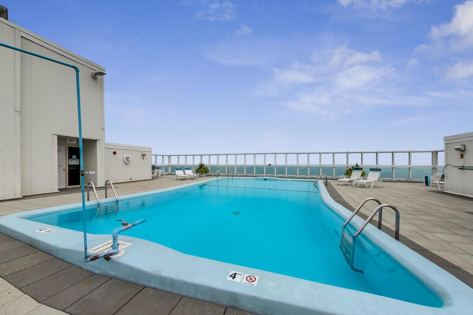 5733 North Sheridan Road, Unit 29D Chicago, IL 60660 - Photo 32 of 40 a view of a swimming pool with a lounge chair