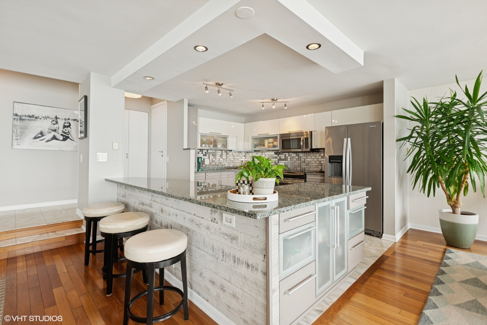 5733 North Sheridan Road, Unit 29D Chicago, IL 60660 - Photo 7 of 40 a kitchen with stainless steel appliances granite countertop a sink and a refrigerator