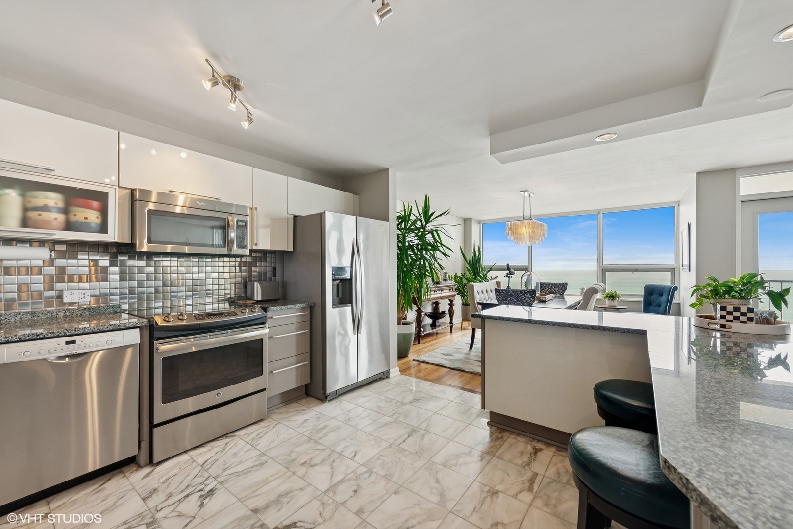 5733 North Sheridan Road, Unit 29D Chicago, IL 60660 - Photo 10 of 40 a kitchen with stainless steel appliances kitchen island granite countertop a stove refrigerator and cabinets