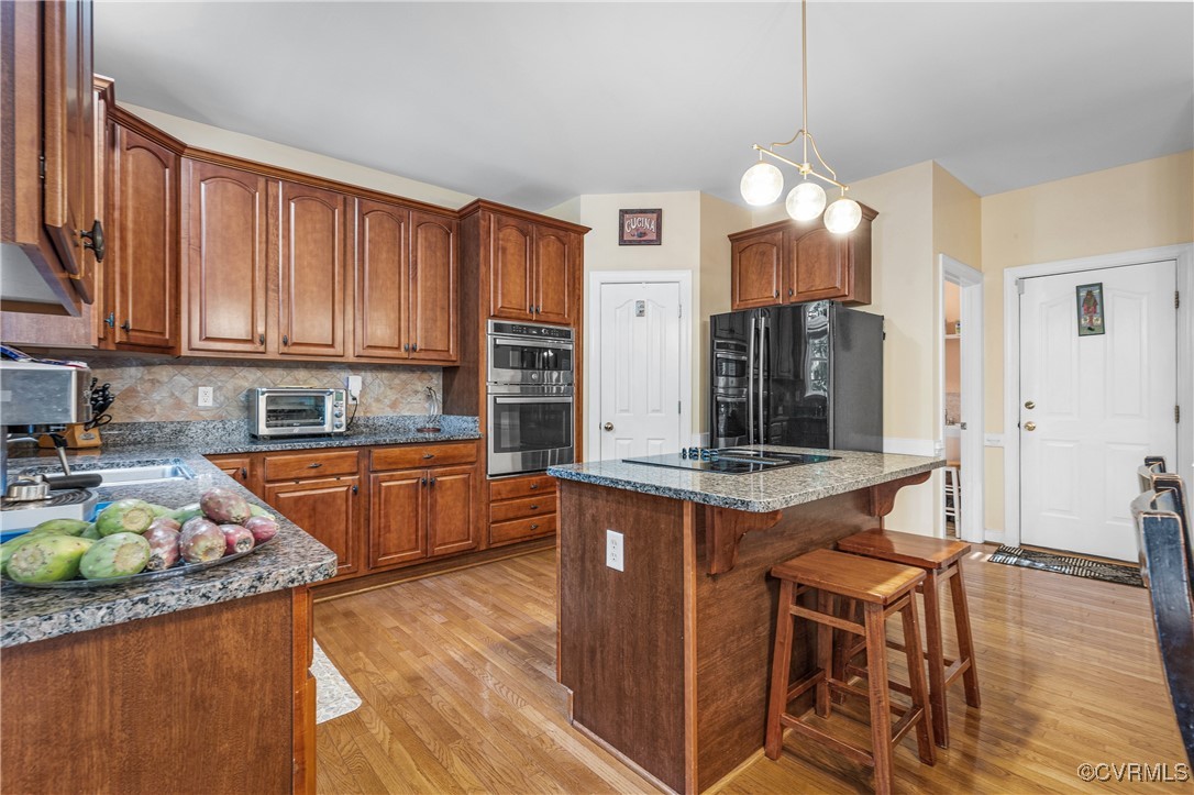 3541 Kings Farm Drive Midlothian, VA 23113 - Photo 12 of 49 a kitchen with stainless steel appliances granite countertop a stove a sink dishwasher and a refrigerator with wooden floor