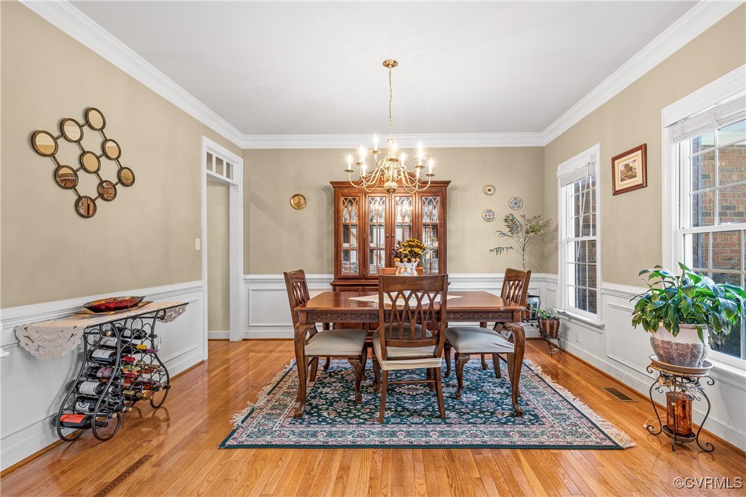 3541 Kings Farm Drive Midlothian, VA 23113 - Photo 6 of 49 a dining room with wooden floor and a chandelier