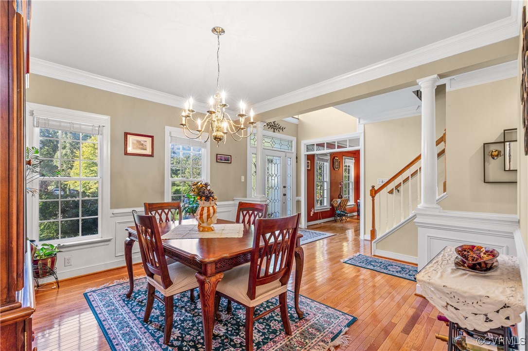 3541 Kings Farm Drive Midlothian, VA 23113 - Photo 7 of 49 a dining room with wooden floor a chandelier a wooden table and chairs