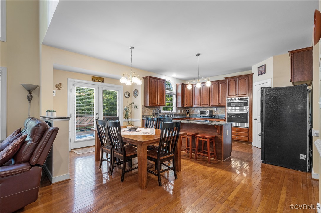 3541 Kings Farm Drive Midlothian, VA 23113 - Photo 10 of 49 a dining hall with stainless steel appliances granite countertop a dining table and chairs
