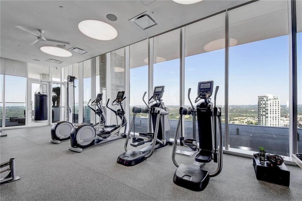 301 West Avenue, Unit 1502 Austin, TX 78701 - Photo 19 of 26 Exercise room with floor to ceiling windows and ceiling fan