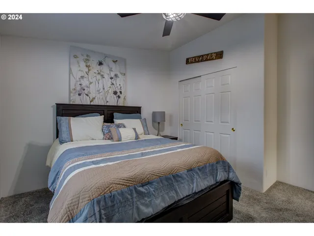 a bedroom with a bed and wall painting