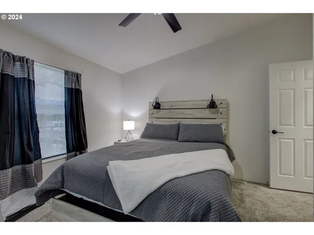 a bedroom with a bed and a large mirror