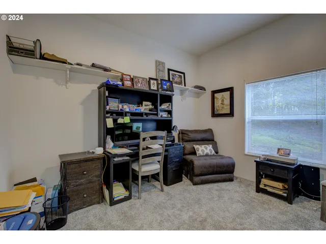 a living room with furniture and a bookshelf