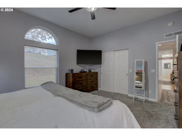 a bed room with a bed and a television