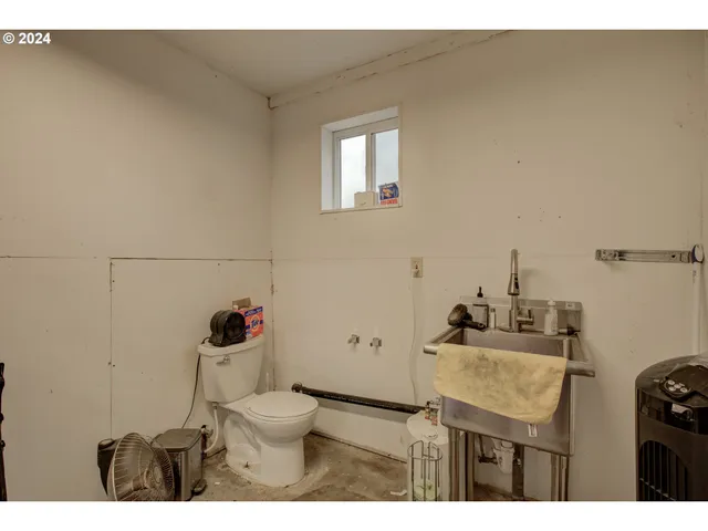 a bathroom with a sink toilet and a mirror