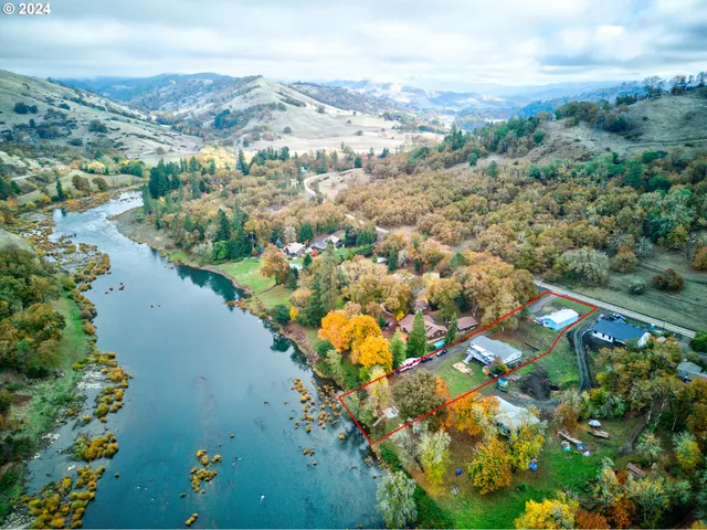 an aerial view of lake residential house with swimming pool and green space