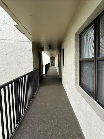 a view of a hallway with seating space