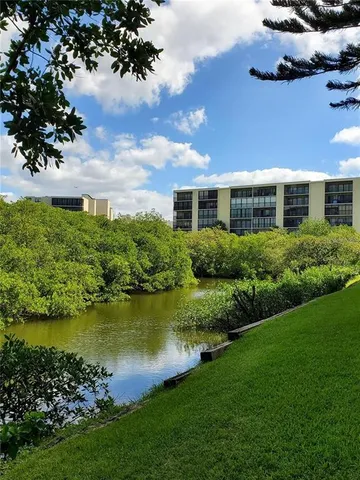 a view of a house with swimming pool and sitting area